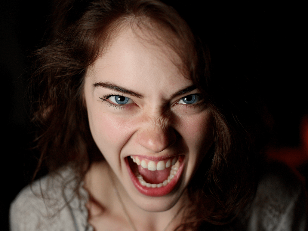 A beautiful woman with blue eyes screaming in anger, symbolizing emotional tension and the need for grounded confidence under pressure